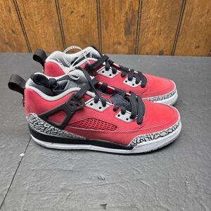 Jordan Kids' Spizike Low shoe in Gym Red, Wolf Grey, and black. 